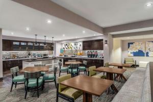 a restaurant with tables and chairs and a kitchen at Homewood Suites by Hilton Providence-Warwick in Warwick