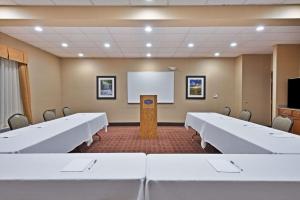 a conference room with white tables and a whiteboard at Hampton Inn Winfield Teays Valley in Teays Valley Estates