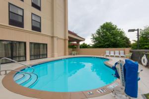 a large blue swimming pool in front of a building at Hampton Inn Wilkesboro in Wilkesboro
