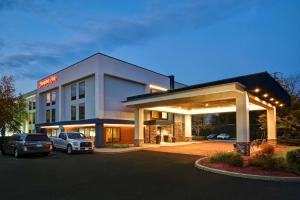 a hotel with cars parked in a parking lot at Hampton Inn White River Junction in White River Junction