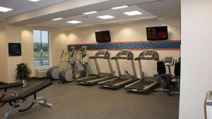 a gym with a row of treadmills and machines at Hampton Inn by Hilton Fort Saskatchewan in Fort Saskatchewan