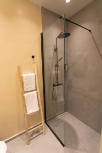 a shower with a glass door in a bathroom at ANASSA apartment in Parga +32 photos