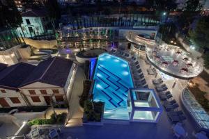 an overhead view of a swimming pool at night at DoubleTree by Hilton Kusadasi in Kuşadası
