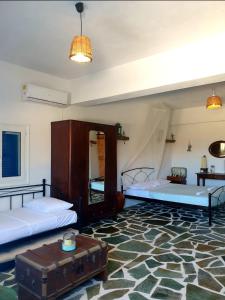 1 dormitorio con 2 camas y alfombra en Anna's Cottage Home en Galini