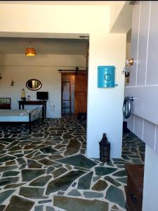 a living room with a stone floor and a couch at Anna's Cottage Home in Galini