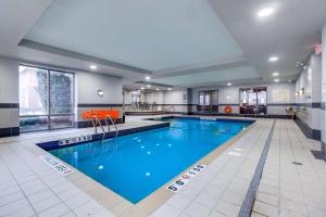 a swimming pool with blue water in a building at Hampton Inn & Suites by Hilton Brantford in Brantford