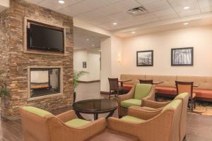 a waiting room with chairs and a fireplace at Hampton Inn by Hilton Edmonton South in Edmonton