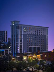 a large building with a sign on it at night at Homewood Suites by Hilton Hamilton in Hamilton