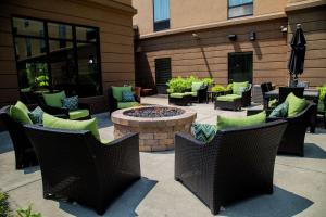 a patio with chairs and a fire pit in front of a building at Hampton Inn & Suites Sharon in West Middlesex