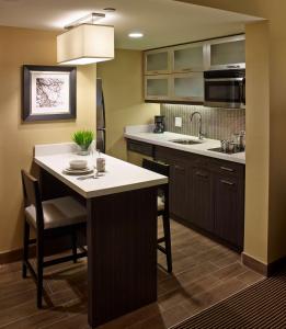 eine Küche mit einer Kücheninsel mit einem Waschbecken in der Unterkunft Homewood Suites by Hilton Hamilton in Hamilton