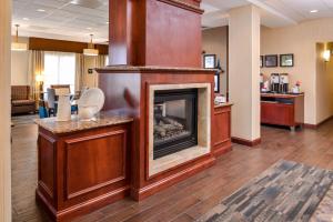 a lobby with a fireplace in a waiting room at Hampton Inn York in York