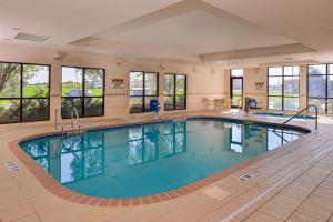 a large swimming pool in a building with windows at Hampton Inn York in York