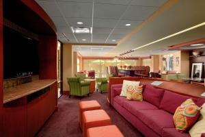 a living room with a pink couch and a bar at Hampton Inn - York in York