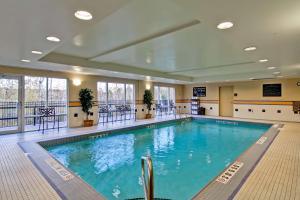 a large swimming pool in a large room with windows at Hampton Inn Sudbury, Ontario in Sudbury