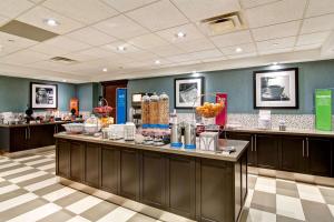 a restaurant with a counter with food on it at Hampton Inn Sudbury, Ontario in Sudbury