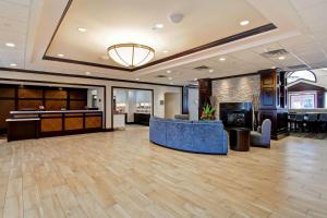 a hotel lobby with a reception desk and a blue couch at Homewood Suites by Hilton Toronto-Mississauga in Mississauga