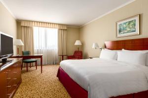 a hotel room with a large bed and a television at Paris Marriott Charles de Gaulle Airport Hotel in Roissy-en-France