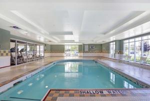 a large indoor swimming pool with blue water at Homewood Suites by Hilton Cambridge-Waterloo, Ontario in Cambridge