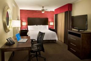 a hotel room with a bed and a desk with a computer at Homewood Suites by Hilton Toronto Vaughan in Vaughan