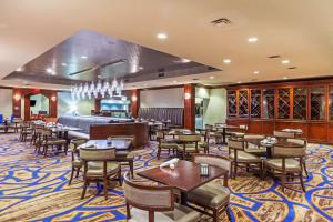 a restaurant with tables and chairs and a bar at Hilton Waco in Waco