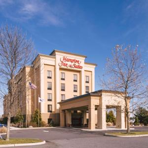 a hotel building with a sign on the front of it at Hampton Inn & Suites Vineland in Vineland