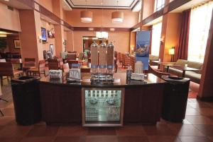 a lobby with a bar with a display in the middle at Hampton Inn & Suites Vineland in Vineland