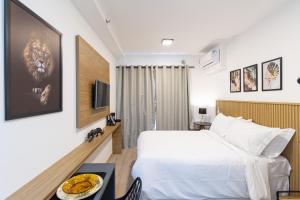 a hotel room with a bed and a television at HMV - Haus Mitre Vila Mariana By Anora Spaces in Sao Paulo