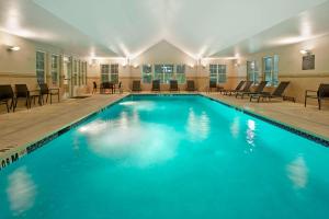 a swimming pool with blue water in a building at Residence Inn Bridgewater Branchburg in Branchburg Park