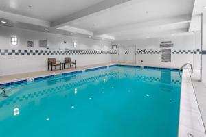 a large pool with blue water in a building at Courtyard by Marriott Winchester Medical Center in Winchester