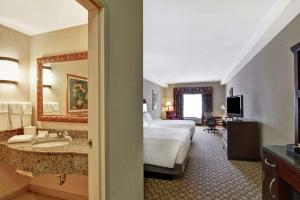 a hotel room with a bed and a bathroom at Hilton Garden Inn Amarillo in Amarillo
