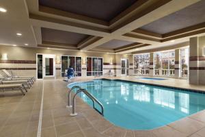 a pool in a hotel lobby with a person in the background at Hilton Garden Inn Oxford/Anniston, AL in Oxford