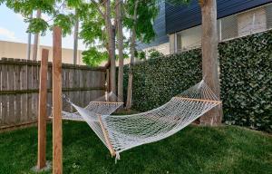 a hammock in a yard next to a fence at White House at Grand Central in Tower Grove