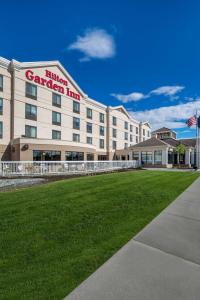 a hotel garden inn with a lawn in front of it at Hilton Garden Inn Anchorage in Anchorage