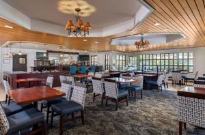 a restaurant with tables and chairs and a bar at DoubleTree Suites by Hilton Naples in Naples