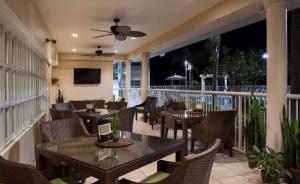 a patio with tables and chairs on a balcony at DoubleTree Suites by Hilton Naples in Naples