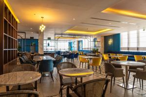 a dining room with tables and chairs and tablesktop at DoubleTree by Hilton Hotel Aqaba in Aqaba