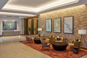 a lobby of a hotel with chairs and tables at Hilton Atlanta Airport in Atlanta