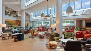 a lobby with a lot of chairs and tables at Hilton Atlanta Airport in Atlanta