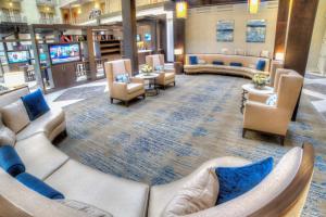 a waiting room with couches and chairs in a hospital at Doubletree Suites by Hilton at The Battery Atlanta in Atlanta