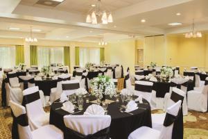 a room filled with tables and chairs with white flowers at Doubletree Suites by Hilton at The Battery Atlanta in Atlanta +96 photos