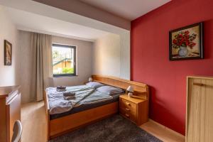 A bed or beds in a room at Máté Pension