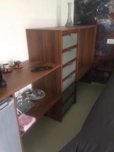 a wooden dresser with drawers and a desk at Ubytování SR in Milovice
