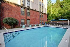 a large swimming pool in front of a building at Hampton Inn Atlanta-Mall Of Georgia in Buford