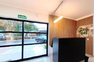 an office with a large glass door to a parking lot at HOTEL RECANTO DOS IPÊS (UNIDADE 2) in Frutal