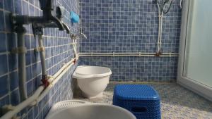 a blue tiled bathroom with a toilet and a sink at Villa 250 m2 terrasse plus Garage in Mostaganem