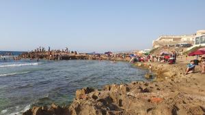 a group of people on a beach near the water at Villa 250 m2 terrasse plus Garage in Mostaganem