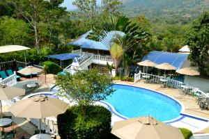 a view of the pool at a resort with umbrellas at Villeta Boutique Hotel Spa in Villeta