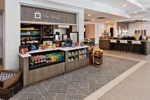a coffee shop with a counter with drinks at Hilton Garden Inn Birmingham/Lakeshore Drive in Birmingham