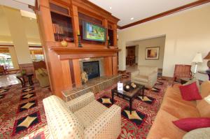 a living room with a fireplace and couches at Hilton Garden Inn Bowling Green in Bowling Green