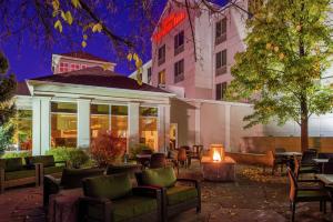 a patio with chairs and tables and a building at Hilton Garden Inn Boise Spectrum in Boise